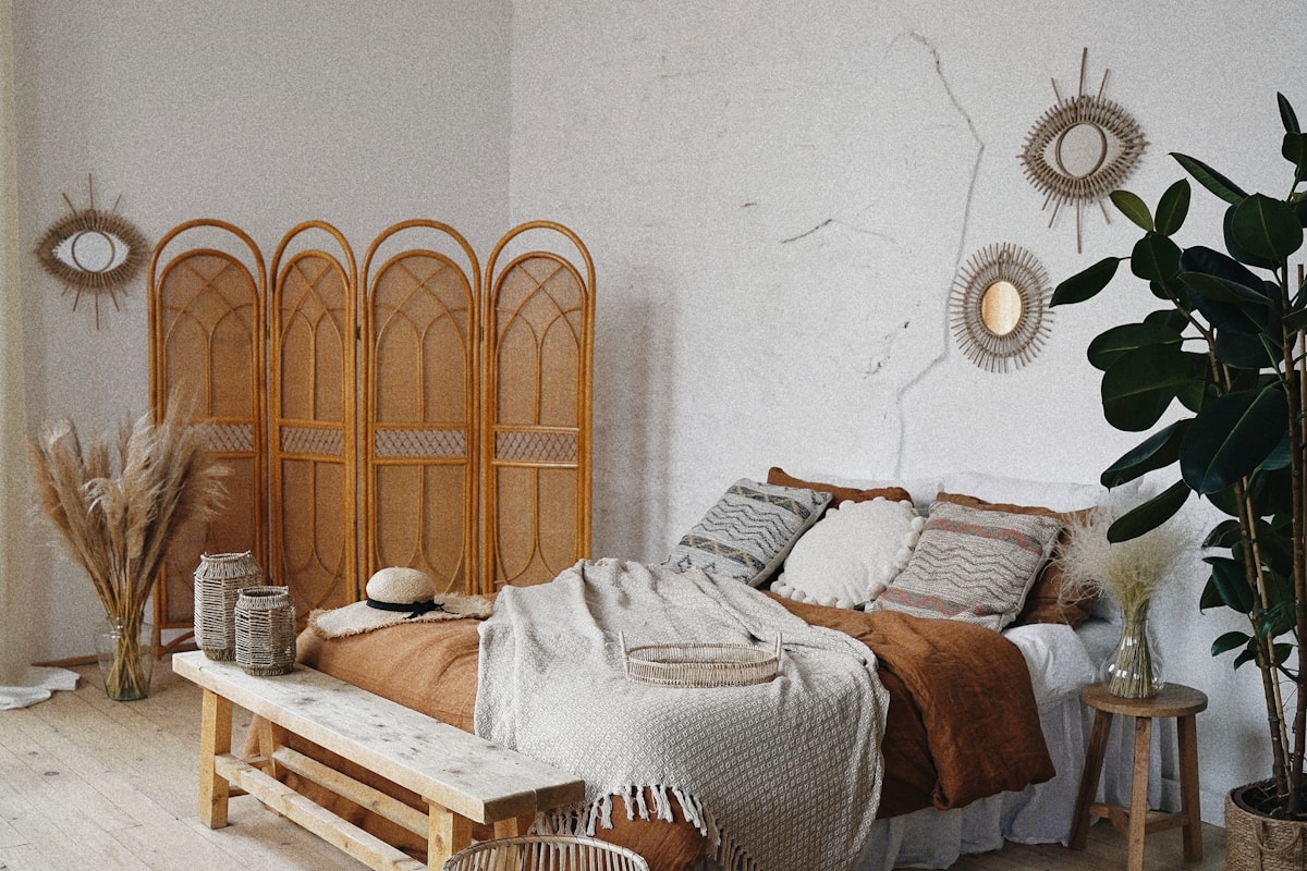 person vacuuming mattress bright bedroom